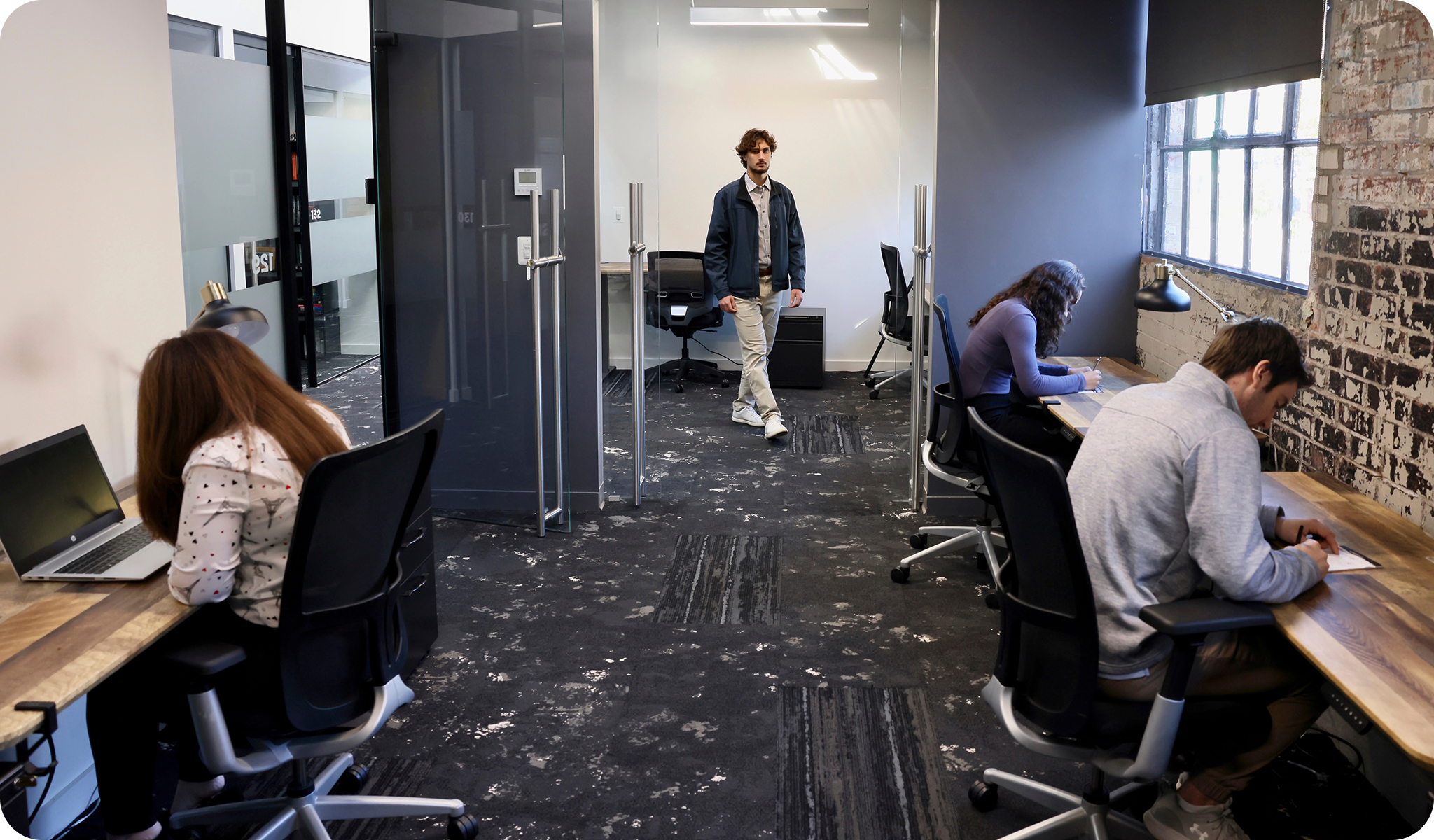 Professionals working in modern coworking Alexandria VA offices at The Link, offering flex plans with shared desks and private spaces.